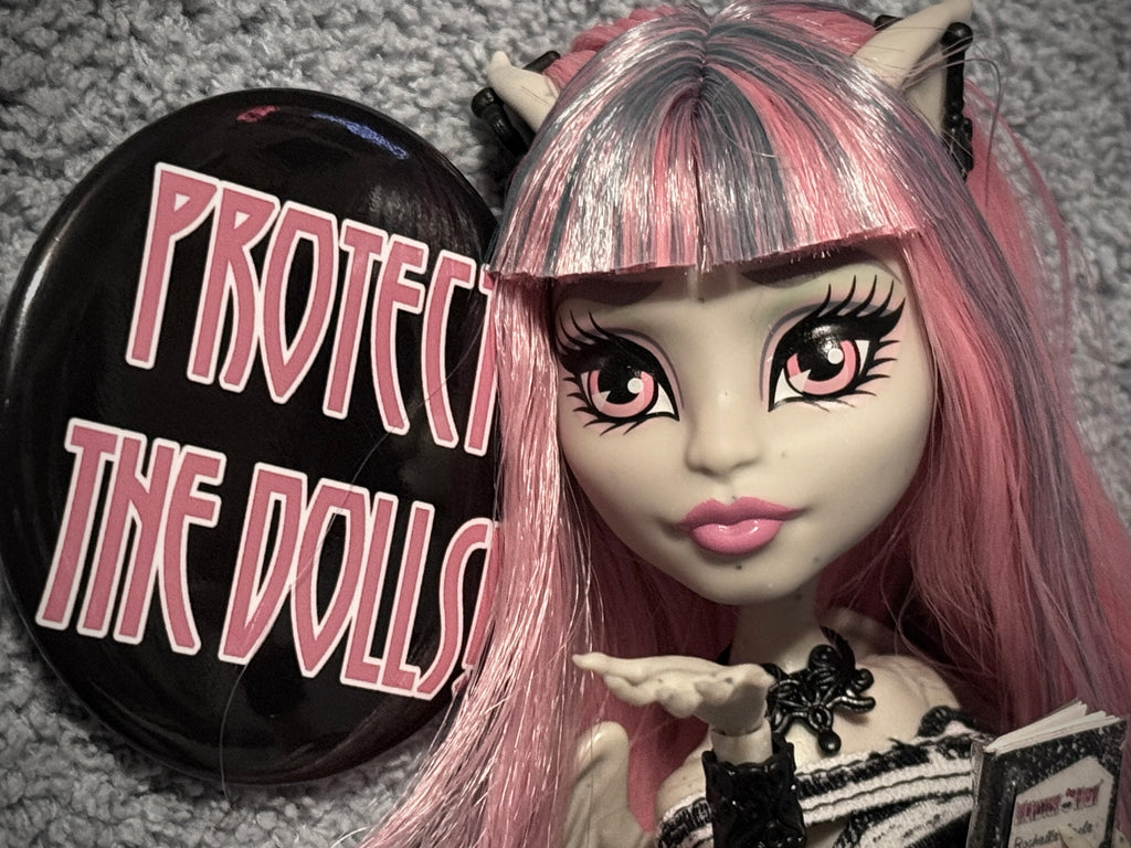 Protect The Dolls Trans 58mm Round Button Pin