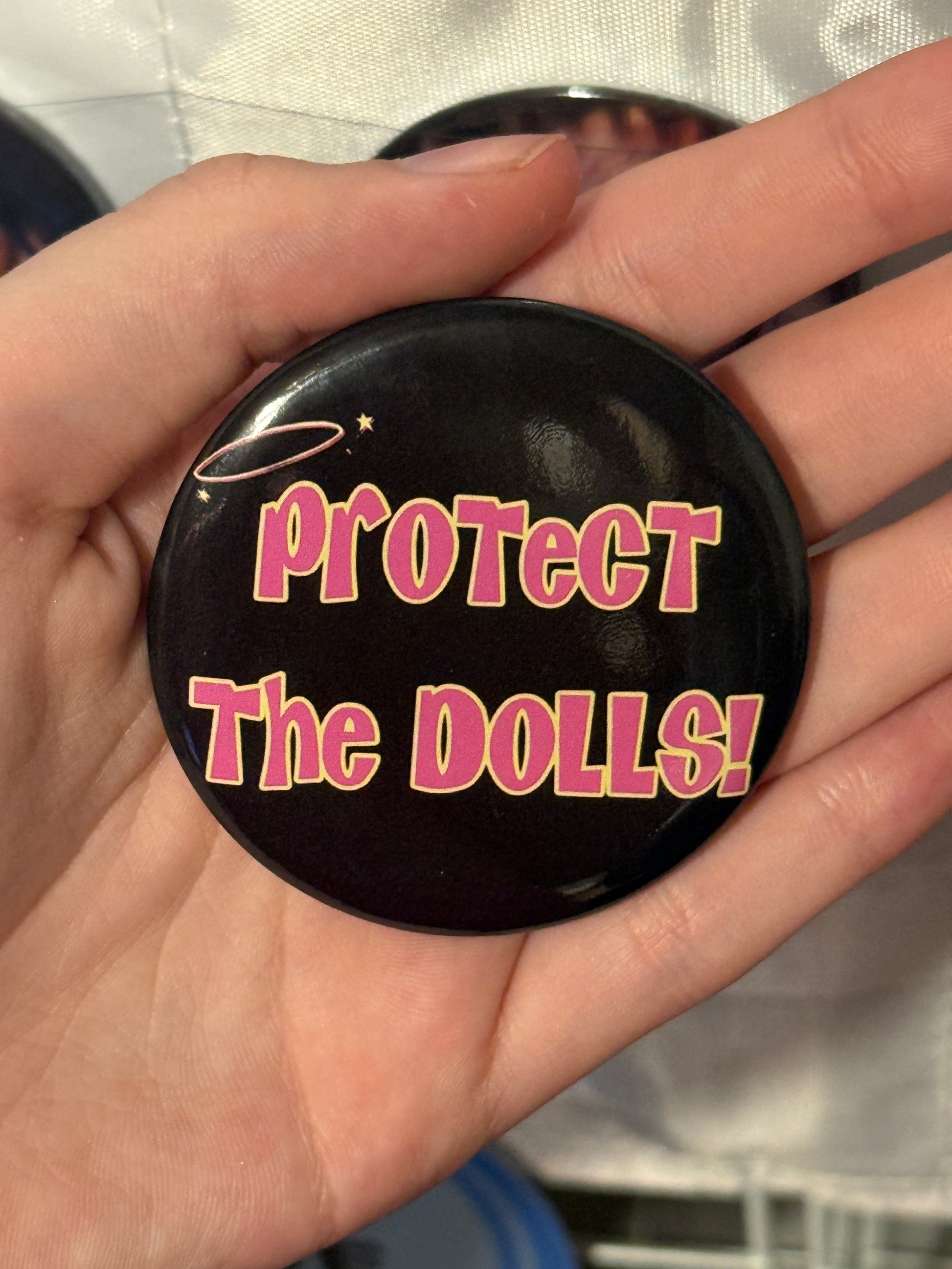 Protect The Dolls Trans 58mm Round Button Pin