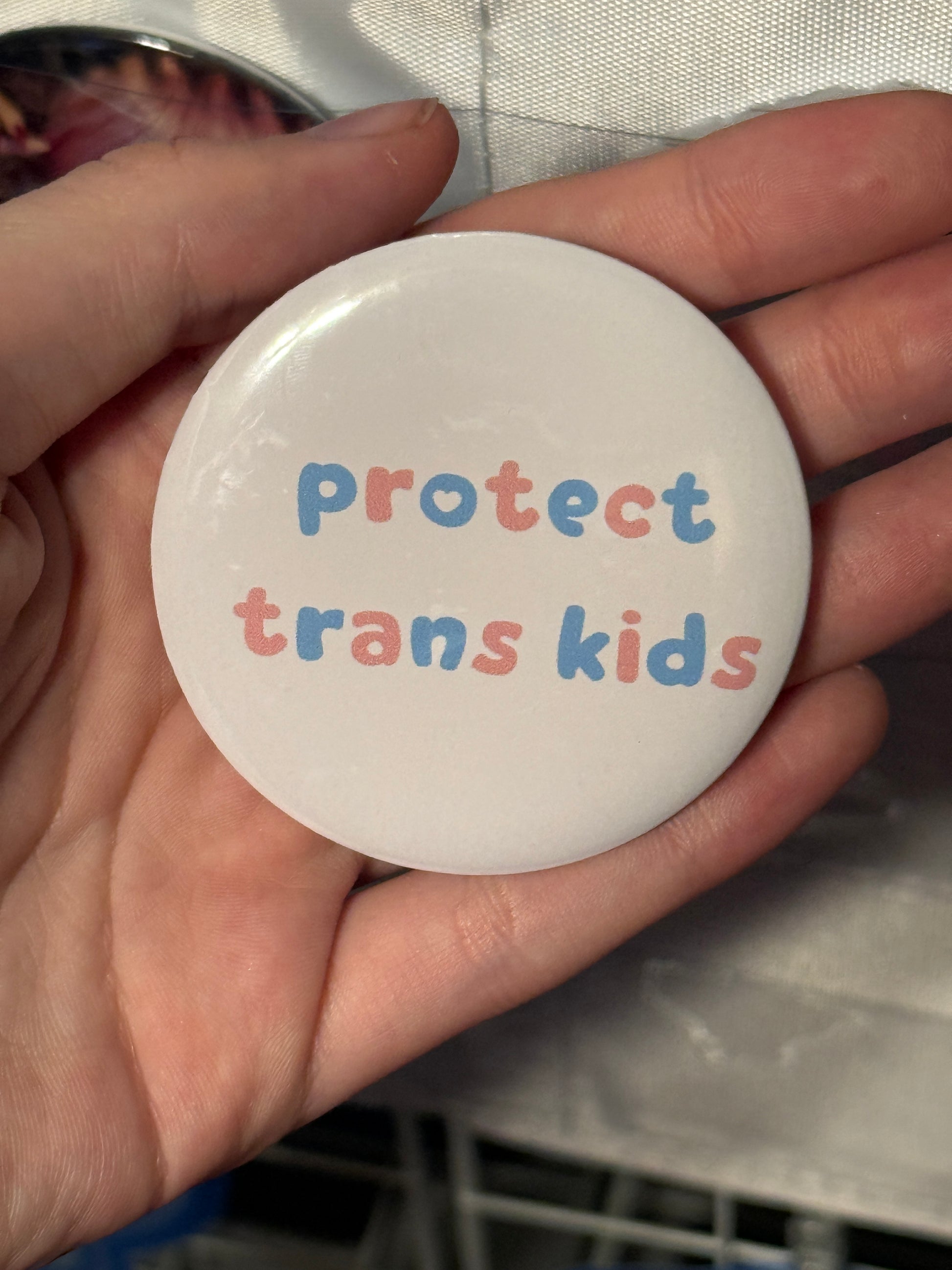 Protect The Dolls Trans 58mm Round Button Pin